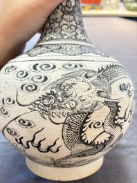 A Chinese black-enamelled biscuit 'dragon' vase, Kangxi mark, 19th C.