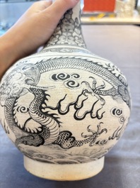 A Chinese black-enamelled biscuit 'dragon' vase, Kangxi mark, 19th C.