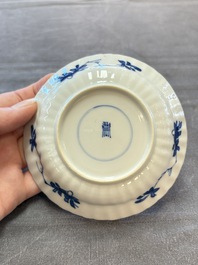 A set of six Chinese blue and white cups and saucers with floral design, Kangxi