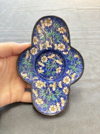 A pair of Chinese blue-ground Canton enamel covered bowls on stands and an egg cup, Qianlong/Jiaqing
