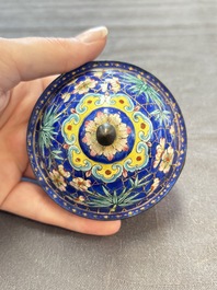 A pair of Chinese blue-ground Canton enamel covered bowls on stands and an egg cup, Qianlong/Jiaqing