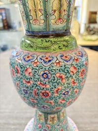A pair of Chinese Canton enamel 'gu' vases with floral design, Qianlong
