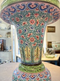 A pair of Chinese Canton enamel 'gu' vases with floral design, Qianlong