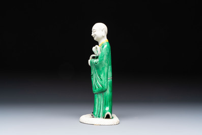 A Chinese verte biscuit Luohan holding a ruyi, Kangxi