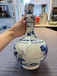 A Chinese blue and white bottle vase with floral design, Transitional period