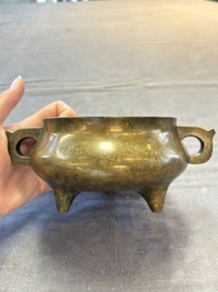A Chinese bronze two-handled tripod censer, 19th C.