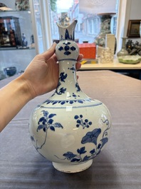 A Chinese blue and white bottle vase with floral design, Transitional period