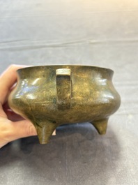 A Chinese bronze two-handled tripod censer, 19th C.
