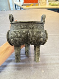 A Chinese archaic bronze tripod food vessel with 'taotie' design, 'ding 鼎', Western Zhou