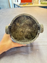 A Chinese archaic bronze tripod food vessel with 'taotie' design, 'ding 鼎', Western Zhou