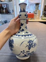A Chinese blue and white bottle vase with floral design, Transitional period