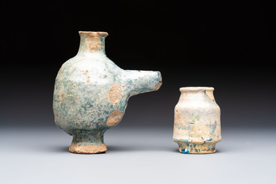 A small turquoise-glazed albarello and three oil lamps, Iran or Syria, 12/13th C.