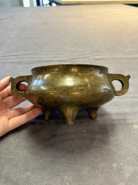 A Chinese bronze two-handled tripod censer, 19th C.