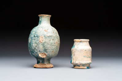 A small turquoise-glazed albarello and three oil lamps, Iran or Syria, 12/13th C.