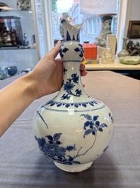 A Chinese blue and white bottle vase with floral design, Transitional period