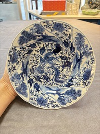 A Chinese blue and white lobed 'phoenix and monkey' plate, flower mark, Kangxi