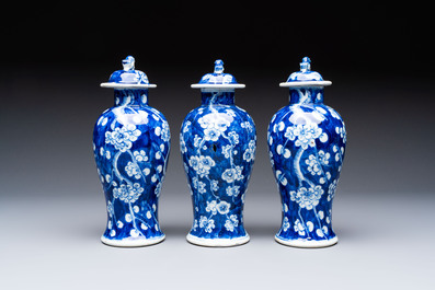 Three Chinese blue and white 'plum blossom' vases and covers, Kangxi mark, 19th C.