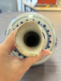 A Chinese blue and white bottle vase with floral design, Transitional period