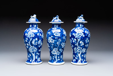 Three Chinese blue and white 'plum blossom' vases and covers, Kangxi mark, 19th C.