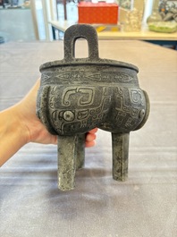 A Chinese archaic bronze tripod food vessel with 'taotie' design, 'ding 鼎', Western Zhou