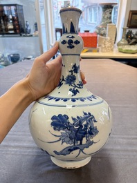 A Chinese blue and white bottle vase with floral design, Transitional period
