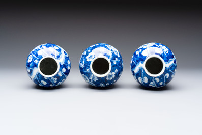 Three Chinese blue and white 'plum blossom' vases and covers, Kangxi mark, 19th C.