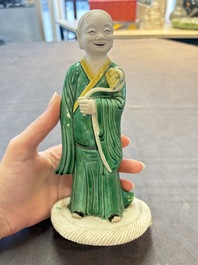A Chinese verte biscuit Luohan holding a ruyi, Kangxi