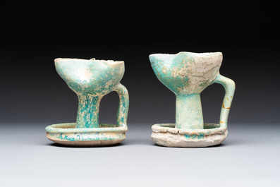 A small turquoise-glazed albarello and three oil lamps, Iran or Syria, 12/13th C.
