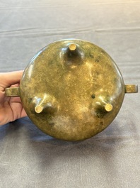 A Chinese bronze two-handled tripod censer, 19th C.