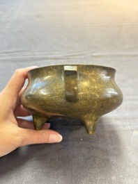 A Chinese bronze two-handled tripod censer, 19th C.