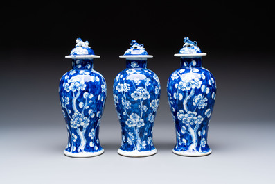 Three Chinese blue and white 'plum blossom' vases and covers, Kangxi mark, 19th C.