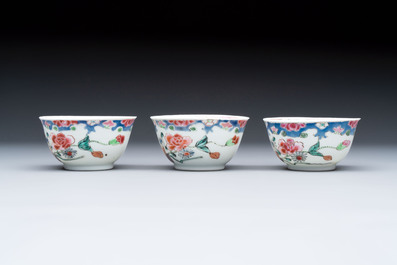 Three Chinese famille rose cups and saucers with a duck among flowering branches, Yongzheng/Qianlong
