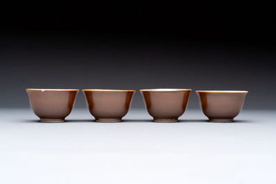 Four Chinese blue and white capucin-ground cups and saucers with landscape design, Yongzheng