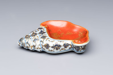A Chinese blue, white and iron-red gilt-decorated conch-form ink palette with landscape design, Jiaqing mark and of the period