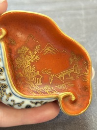 A Chinese blue, white and iron-red gilt-decorated conch-form ink palette with landscape design, Jiaqing mark and of the period