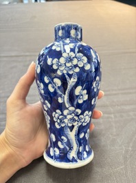 Three Chinese blue and white 'plum blossom' vases and covers, Kangxi mark, 19th C.
