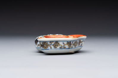 A Chinese blue, white and iron-red gilt-decorated conch-form ink palette with landscape design, Jiaqing mark and of the period