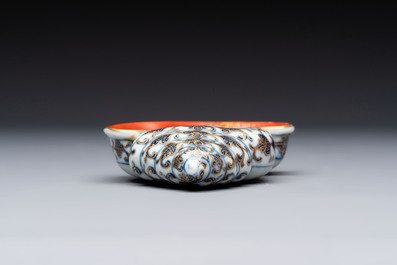 A Chinese blue, white and iron-red gilt-decorated conch-form ink palette with landscape design, Jiaqing mark and of the period