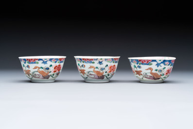 Three Chinese famille rose cups and saucers with a duck among flowering branches, Yongzheng/Qianlong