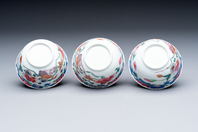 Three Chinese famille rose cups and saucers with a duck among flowering branches, Yongzheng/Qianlong