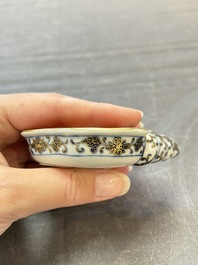 A Chinese blue, white and iron-red gilt-decorated conch-form ink palette with landscape design, Jiaqing mark and of the period