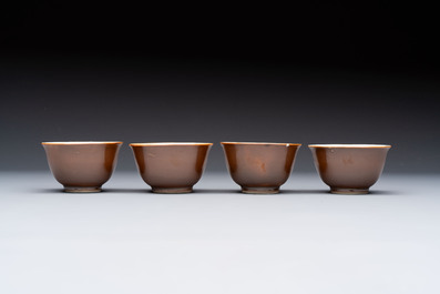 Four Chinese blue and white capucin-ground cups and saucers with landscape design, Yongzheng