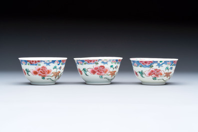 Three Chinese famille rose cups and saucers with a duck among flowering branches, Yongzheng/Qianlong
