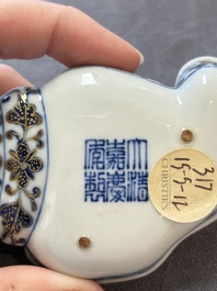 A Chinese blue, white and iron-red gilt-decorated conch-form ink palette with landscape design, Jiaqing mark and of the period