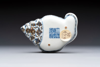 A Chinese blue, white and iron-red gilt-decorated conch-form ink palette with landscape design, Jiaqing mark and of the period