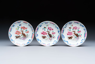 Three Chinese famille rose cups and saucers with a duck among flowering branches, Yongzheng/Qianlong