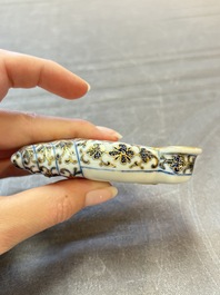 A Chinese blue, white and iron-red gilt-decorated conch-form ink palette with landscape design, Jiaqing mark and of the period