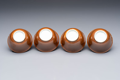 Four Chinese blue and white capucin-ground cups and saucers with landscape design, Yongzheng