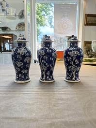 Three Chinese blue and white 'plum blossom' vases and covers, Kangxi mark, 19th C.