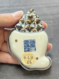A Chinese blue, white and iron-red gilt-decorated conch-form ink palette with landscape design, Jiaqing mark and of the period